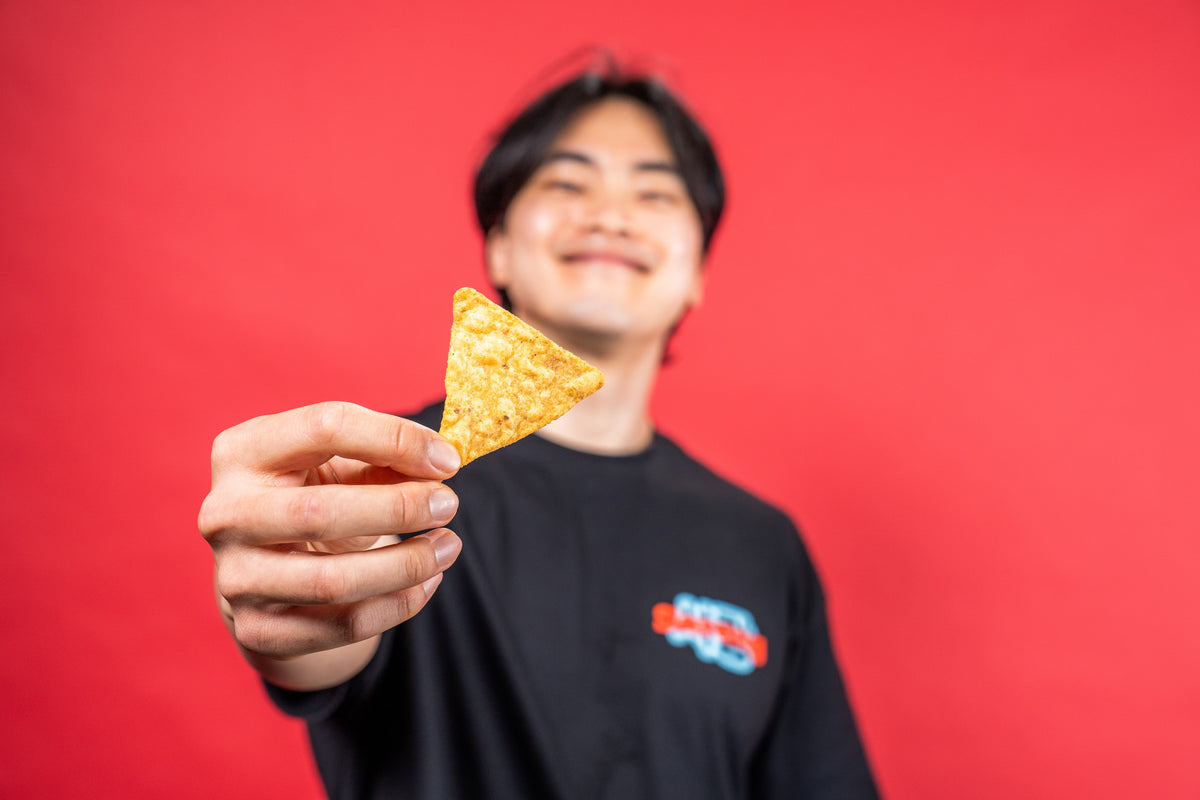 Co-founder Hochun holding out a Sarang chip on a red background