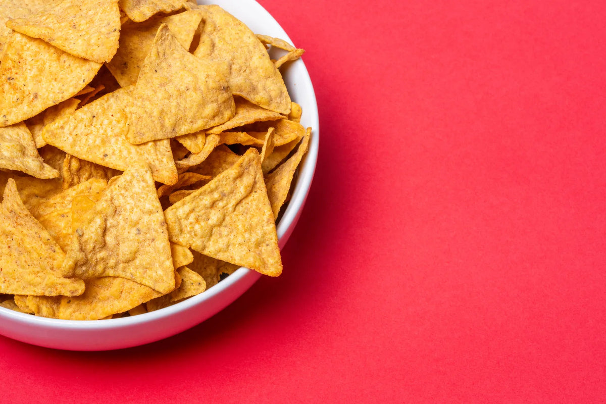 Bowl of Sarang tortilla chips on a red background